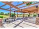 Covered picnic area featuring metal tables and stone pillars, providing a comfortable outdoor gathering space at 4323 S Ranger Trl, Gilbert, AZ 85297