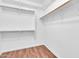 Spacious walk-in closet with shelves and wooden rods, offering ample storage space and organization at 4323 S Ranger Trl, Gilbert, AZ 85297