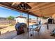 Patio area with outdoor seating, a grill, and partial backyard view, ideal for entertaining at 4403 N 56Th Dr, Phoenix, AZ 85031