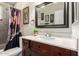 Bathroom featuring a vanity with a framed mirror and a decorative plant, providing a fresh aesthetic at 4403 N 56Th Dr, Phoenix, AZ 85031