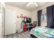 Bedroom featuring a bed with patterned bedding, a fan, and a television on a storage unit at 4403 N 56Th Dr, Phoenix, AZ 85031