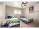 Bedroom with two beds, a ceiling fan, and natural light from the window, offering a comfortable retreat at 4403 N 56Th Dr, Phoenix, AZ 85031