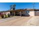 Single story home with covered front porch, solar panels, and spacious driveway at 4403 N 56Th Dr, Phoenix, AZ 85031
