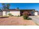 Charming single story home with a covered porch and colorful front yard plants at 4403 N 56Th Dr, Phoenix, AZ 85031