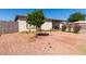 Landscaped front yard featuring mature shade tree, desert landscaping, and covered entry at 4403 N 56Th Dr, Phoenix, AZ 85031