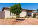 Well-maintained home with desert landscaping, mature trees, and a covered patio area at 4403 N 56Th Dr, Phoenix, AZ 85031