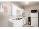 Functional kitchen featuring white cabinets, essential appliances, and a double basin sink at 4403 N 56Th Dr, Phoenix, AZ 85031
