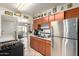 Cozy kitchen with stainless steel appliances, wood cabinets, and a view to the backyard at 4403 N 56Th Dr, Phoenix, AZ 85031