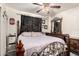 Charming main bedroom with an ornate iron bed frame, dark wooden furniture, and decorative accents at 4403 N 56Th Dr, Phoenix, AZ 85031
