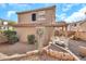 Enjoy the outdoors in this backyard with desert landscaping and a charming covered patio area at 450 W Mountain Sage Dr, Phoenix, AZ 85045