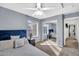 Comfortable bedroom with a ceiling fan, carpet, and mirrored closet doors at 450 W Mountain Sage Dr, Phoenix, AZ 85045