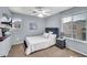 Cozy bedroom with plush carpet, ceiling fan, and a window with neighborhood views at 450 W Mountain Sage Dr, Phoenix, AZ 85045