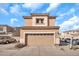 Exterior view of the home featuring a garage door, desert landscaping, and a neutral color scheme at 450 W Mountain Sage Dr, Phoenix, AZ 85045