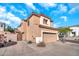 Two-story stucco home with a two-car garage, tiled roof, and desert landscaping under a beautiful blue sky at 450 W Mountain Sage Dr, Phoenix, AZ 85045