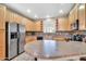 Spacious kitchen featuring stainless steel appliances, wooden cabinets and large island at 450 W Mountain Sage Dr, Phoenix, AZ 85045
