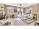 Bright living room with sliding glass doors, tile flooring, and neutral decor at 450 W Mountain Sage Dr, Phoenix, AZ 85045