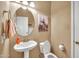 Well-lit half bath with modern fixtures, vanity sink, and neutral color palette at 450 W Mountain Sage Dr, Phoenix, AZ 85045