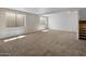Spacious basement with plush carpeting, recessed lighting, and natural light creates a comfortable living space at 5520 E Muriel Dr, Scottsdale, AZ 85254