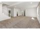 Expansive basement features neutral carpeting, recessed lighting, and versatile open layout, ideal for entertaining at 5520 E Muriel Dr, Scottsdale, AZ 85254