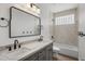 Bright bathroom with dual sinks, stone countertops, modern fixtures and a separate tub and shower at 5520 E Muriel Dr, Scottsdale, AZ 85254