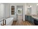 Relaxing bathroom with soaking tub, modern vanity, and an open doorway to the bedroom at 5520 E Muriel Dr, Scottsdale, AZ 85254