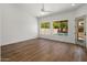 Bright bedroom with hardwood floors, ceiling fan, and views of the backyard pool at 5520 E Muriel Dr, Scottsdale, AZ 85254