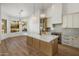 Gourmet kitchen featuring a waterfall island, quartz countertops, and stainless steel appliances at 5520 E Muriel Dr, Scottsdale, AZ 85254