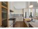 Modern kitchen featuring a breakfast bar, designer cabinetry, and stainless steel appliances at 5520 E Muriel Dr, Scottsdale, AZ 85254