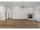 Bright living room boasts a modern fireplace, neutral paint, and wood-look floors at 5520 E Muriel Dr, Scottsdale, AZ 85254