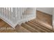 Carpeted staircase with white railing connects floors, offering a safe and stylish transition in the home at 5520 E Muriel Dr, Scottsdale, AZ 85254