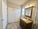 Bathroom featuring double wide storage cabinets, vanity, sink, mirror and lighting at 591 S Ironstone Dr, Apache Junction, AZ 85119
