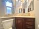 Bathroom features a vanity with dark wood cabinet and drawers plus beige tiling at 591 S Ironstone Dr, Apache Junction, AZ 85119