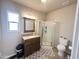 Bright bathroom with vanity, mirror, glass shower, toilet and gray patterned rug at 591 S Ironstone Dr, Apache Junction, AZ 85119