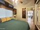Bedroom featuring built-in cabinets, ceiling fan and a view out to another room at 591 S Ironstone Dr, Apache Junction, AZ 85119