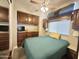 Cozy bedroom featuring full wall of built-in cabinets and drawers, side tables and a ceiling fan at 591 S Ironstone Dr, Apache Junction, AZ 85119