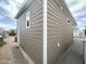 Well-maintained home exterior featuring light brown horizontal siding, and a small window at 591 S Ironstone Dr, Apache Junction, AZ 85119