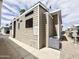 Well-maintained home exterior featuring light brown horizontal siding, an AC unit, and a concrete walkway at 591 S Ironstone Dr, Apache Junction, AZ 85119