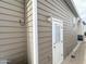 Home exterior with a light and bright door with light fixture on light brown horizontal siding at 591 S Ironstone Dr, Apache Junction, AZ 85119