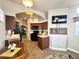 Modern kitchen featuring dark wood cabinets, sleek black appliances, and a view into the living area at 591 S Ironstone Dr, Apache Junction, AZ 85119