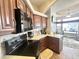 Functional kitchen with wood cabinets, modern appliances, and a view into the living area at 591 S Ironstone Dr, Apache Junction, AZ 85119