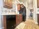Practical kitchen equipped with black appliances and warm wood cabinets, seamlessly connecting spaces at 591 S Ironstone Dr, Apache Junction, AZ 85119