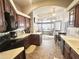 Well-appointed kitchen showcasing dark wood cabinets, modern appliances, and a seamless transition to the living room at 591 S Ironstone Dr, Apache Junction, AZ 85119