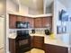 Spacious kitchen featuring wood cabinets, modern appliances, and ample countertop space at 591 S Ironstone Dr, Apache Junction, AZ 85119