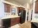 Efficient kitchen setup featuring black appliances and storage with a serving window at 591 S Ironstone Dr, Apache Junction, AZ 85119