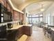Efficient kitchen with wood cabinetry and black appliances, flowing into the open living space at 591 S Ironstone Dr, Apache Junction, AZ 85119