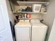 Organized laundry room with a washer and dryer and ample shelving for storage and supplies at 591 S Ironstone Dr, Apache Junction, AZ 85119