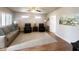 Spacious living room features a ceiling fan, wood floors, large windows and neutral color palette at 591 S Ironstone Dr, Apache Junction, AZ 85119