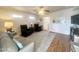 Living room includes wood floors, ceiling fan, and plenty of room for seating at 591 S Ironstone Dr, Apache Junction, AZ 85119