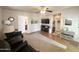 Comfortable living room with hardwood floors, neutral colors, and a view to the bathroom and hallway at 591 S Ironstone Dr, Apache Junction, AZ 85119