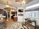 Open-concept living area connects to a kitchen and boasts a mounted TV, desk, and natural light at 591 S Ironstone Dr, Apache Junction, AZ 85119
